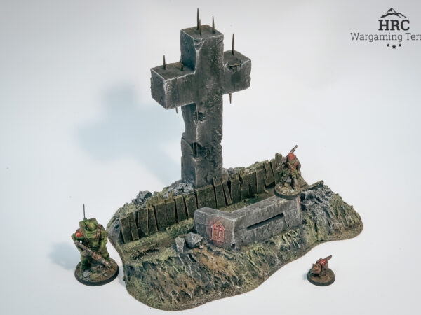 Close-up of bullet-scarred concrete and massive cross on Defender of the Faith bunker terrain.