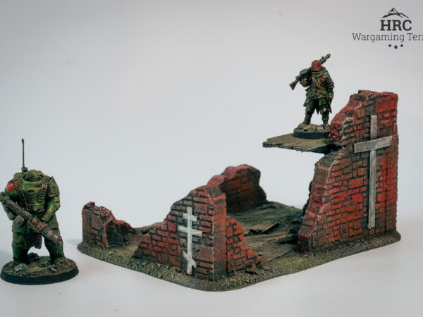 Inside of a ruined defensive position with painted crosses, grimdark terrain for skirmish wargames.