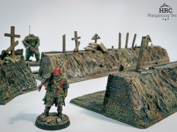 Reinforced trench walls with timber and sharpened stakes, hand-painted grimdark scenery.